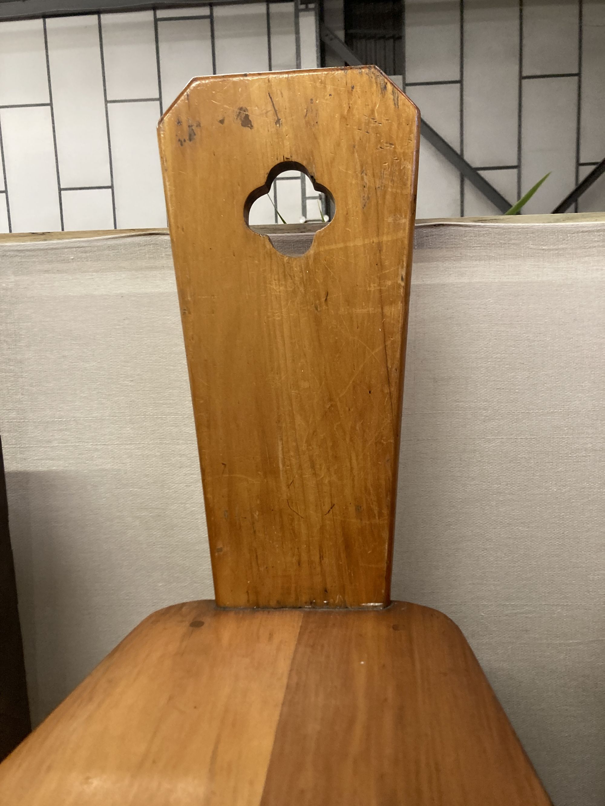 A pair of Italian style pitch pine hall chairs, stamped underneath R.Woolfe and J. Hadaway, width 38cm depth 50cm height 98cm